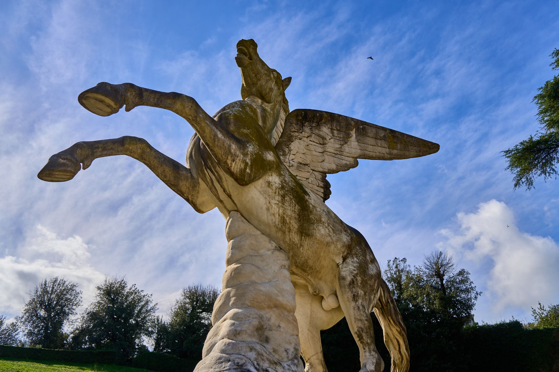 A Pegasus statue against a blue sky